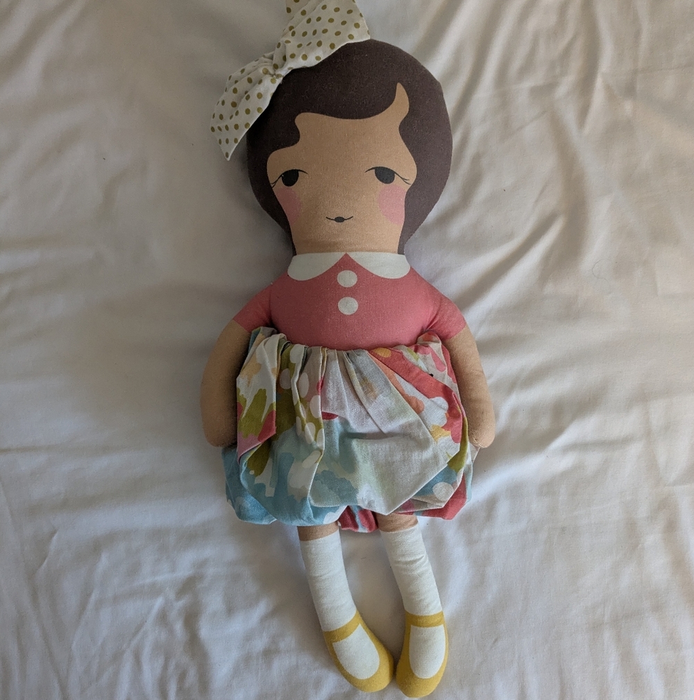 Adorable Pink and Brown Doll with Colorful Skirt